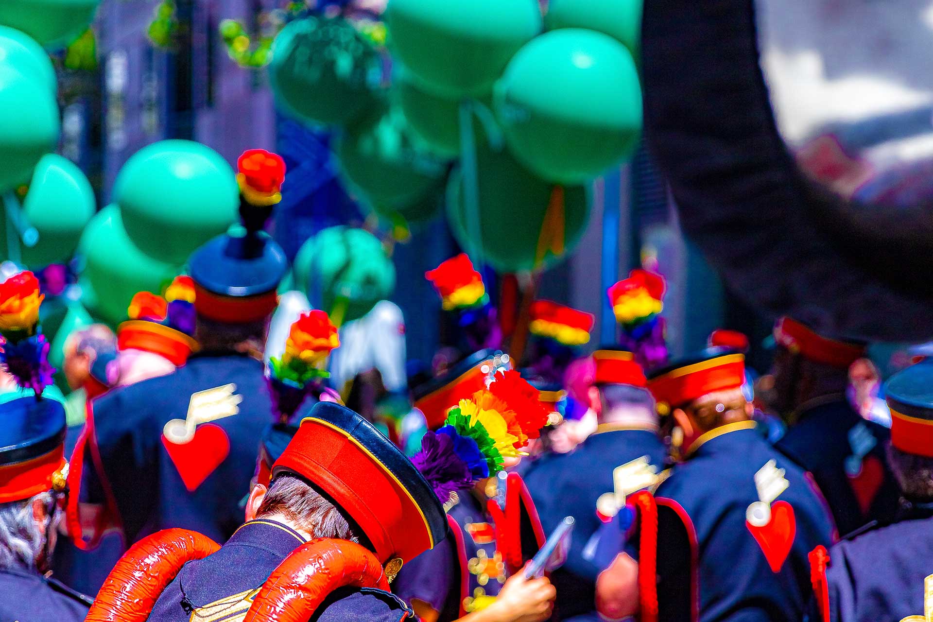 Freedom Band marching band — rainbow plumes and red-and-black uniforms